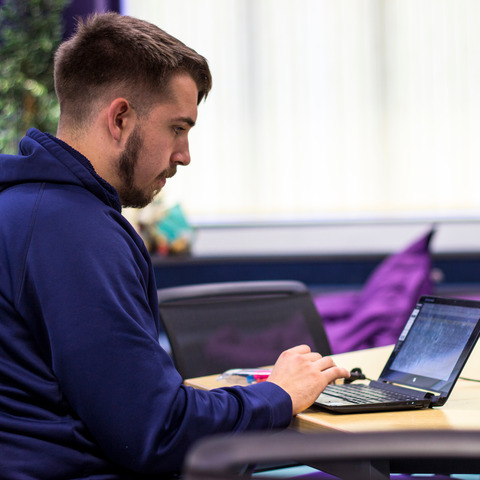 Marjon student working at a laptop.