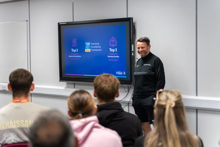 Male lecturer at Marjon smiling at the room of people