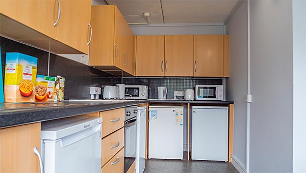 Kitchen with fridges, freezers, cooker and hob