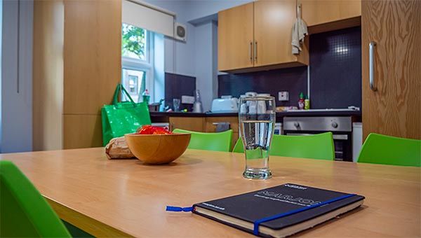 Looking across dining table to the kitchen