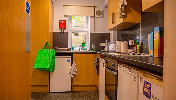 Kitchen with fridges, freezer, cooker, hob and sink