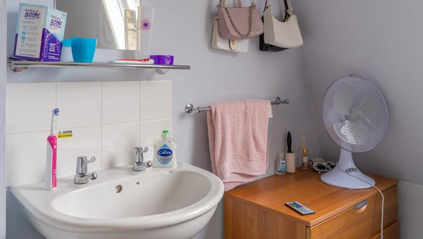 Basin, mirror and towel rail in a bedroom