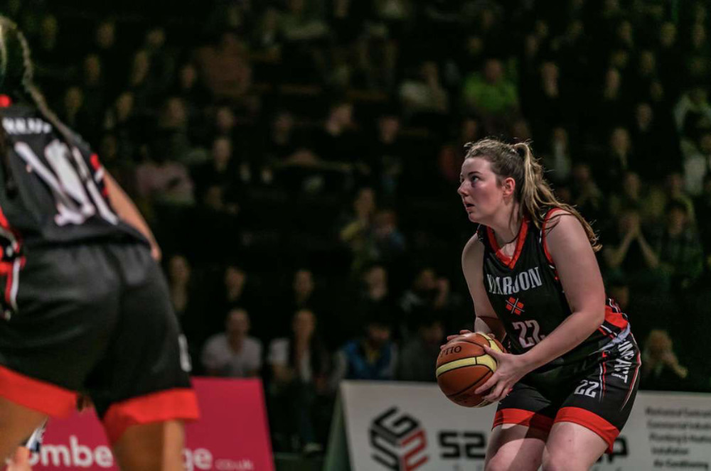 A Marjon alumni playing professional basketball. She is about to score a three-pointer.