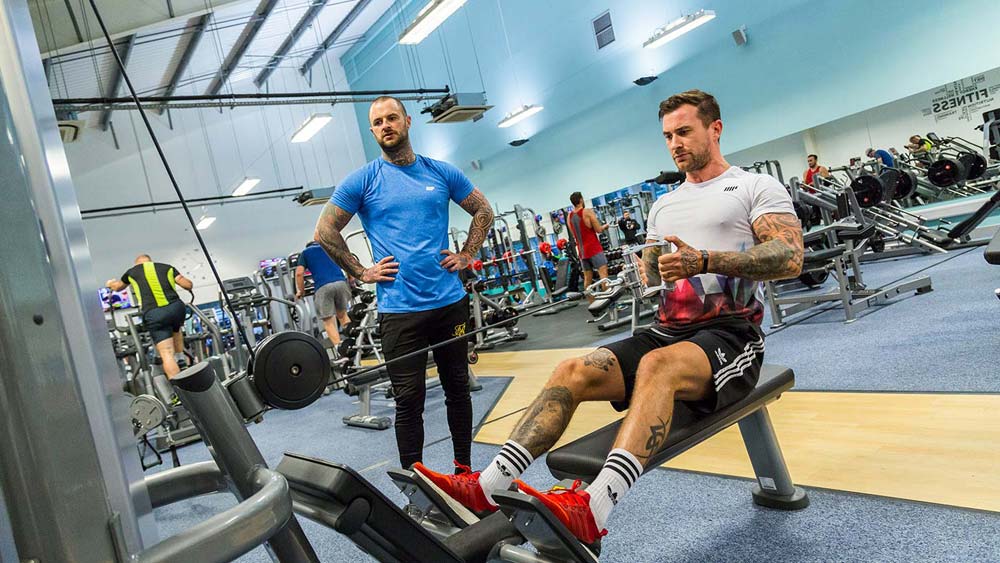 Member using a rowing machine in the gym