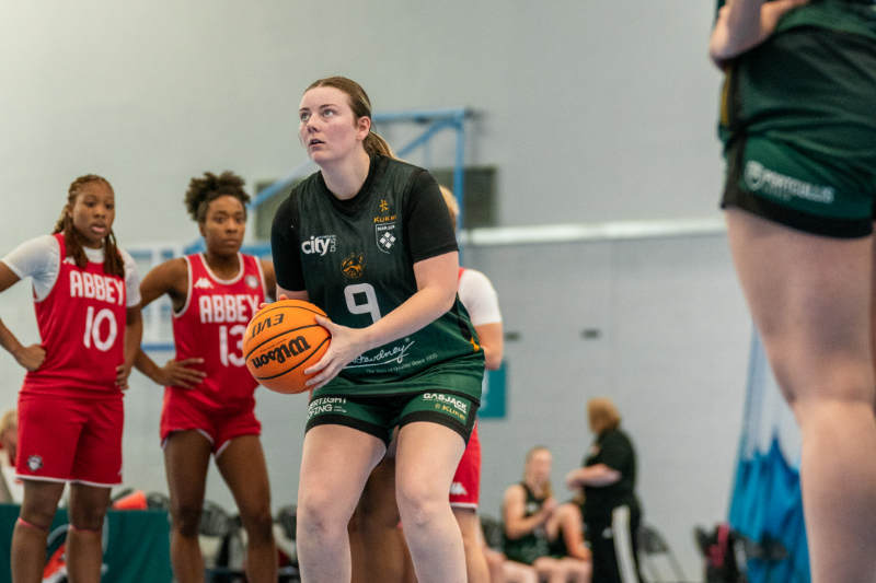 Female student athlete taking a free throw in a basketball game