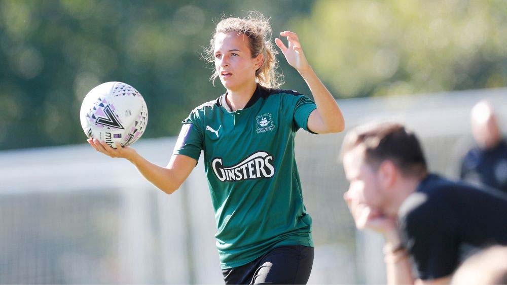 Young women footballer from Plymouth Argyle takes a throw in
