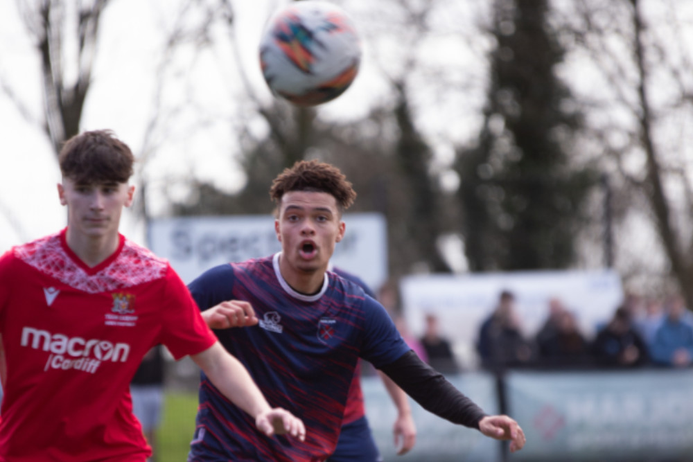 A player from the Marjon men's football team is about to head the football