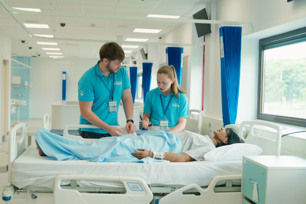 male and female student ambassadors in the nursing sim suite