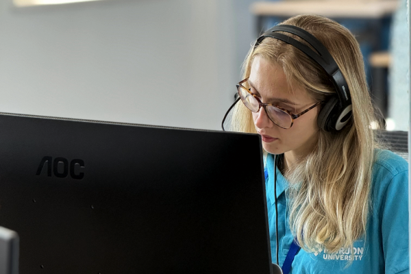 female student with a headset on making phone calls
