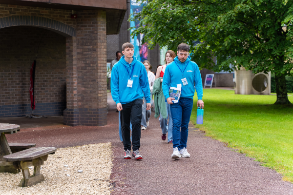 two student ambassadors giving a group of people a campus tour