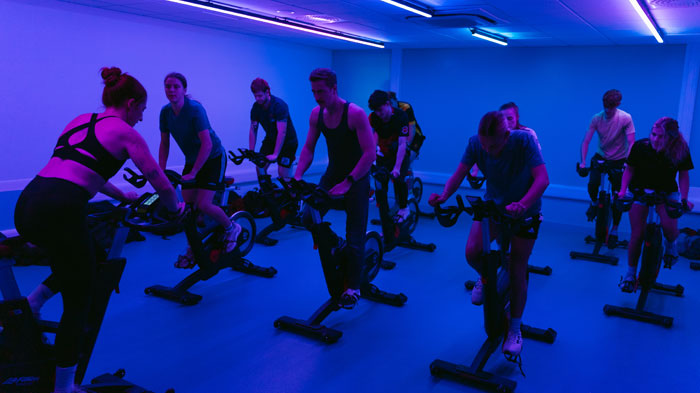 Students participating in cycle spinning fitness class