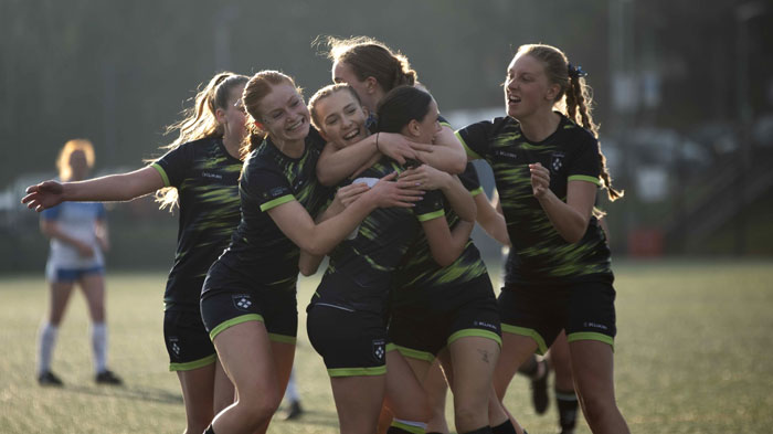Sports team celebrating victory, congratulating each other