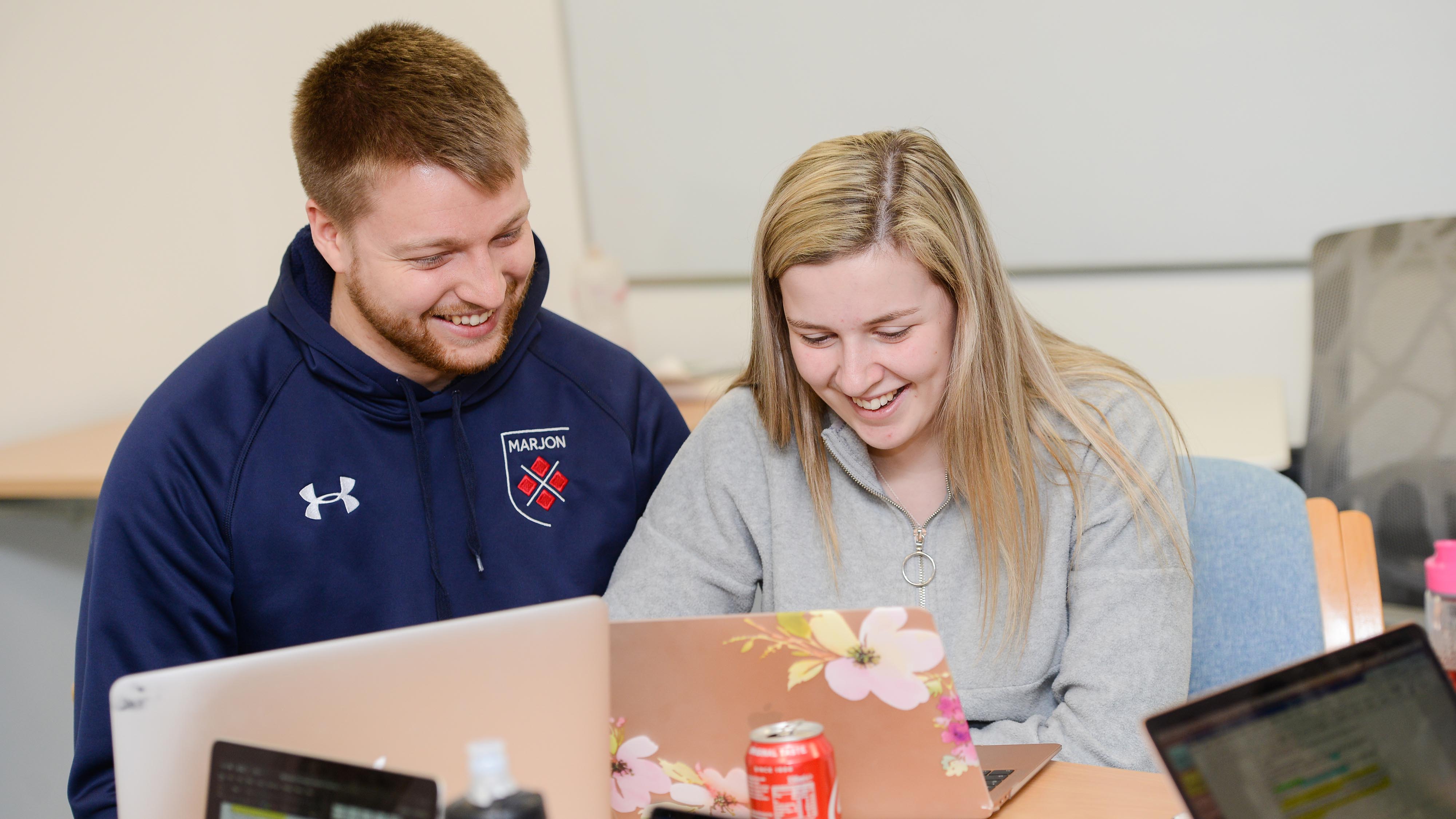 Two friends chatting as they study