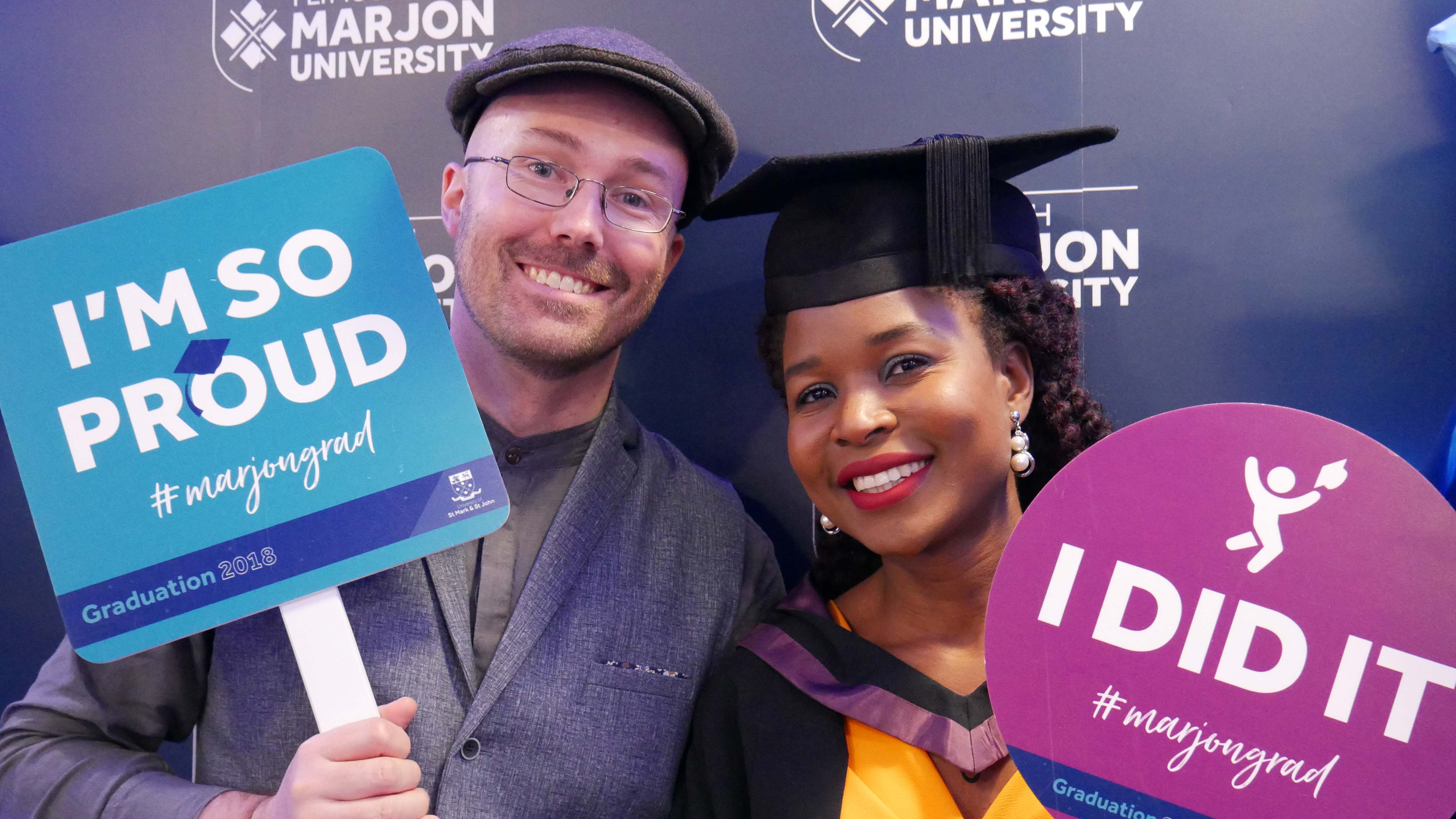 Graduate and supporter celebrating at Graduation