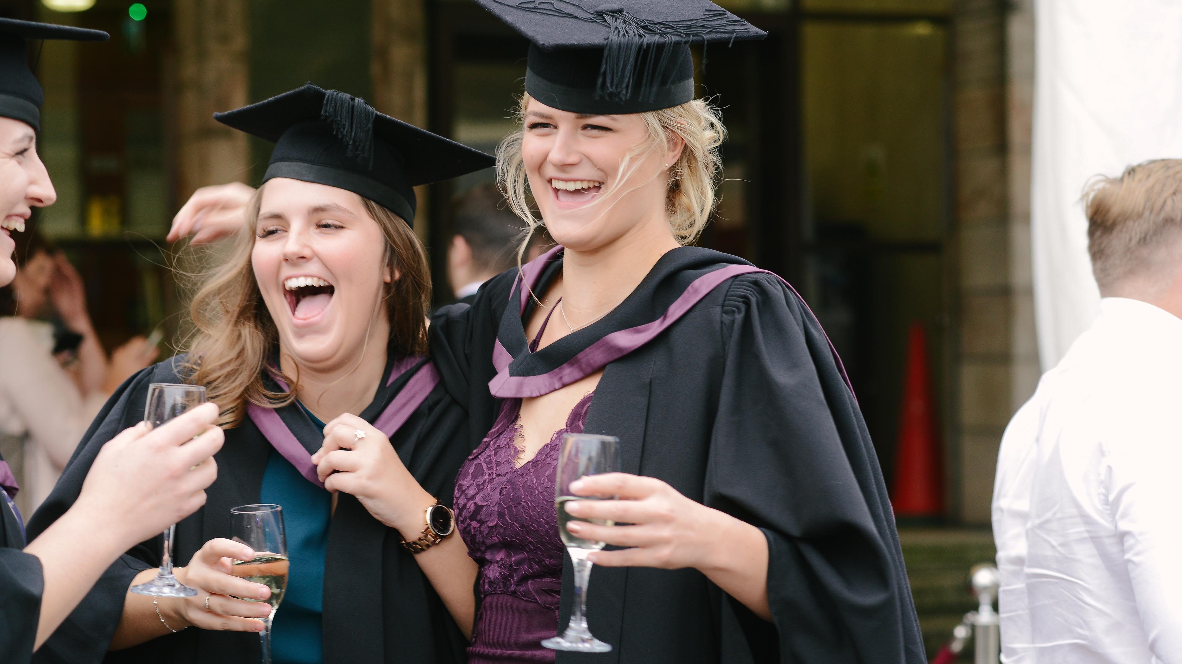 Friends laughing together at Graduation