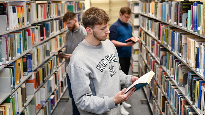 Students amongst books in our campus library