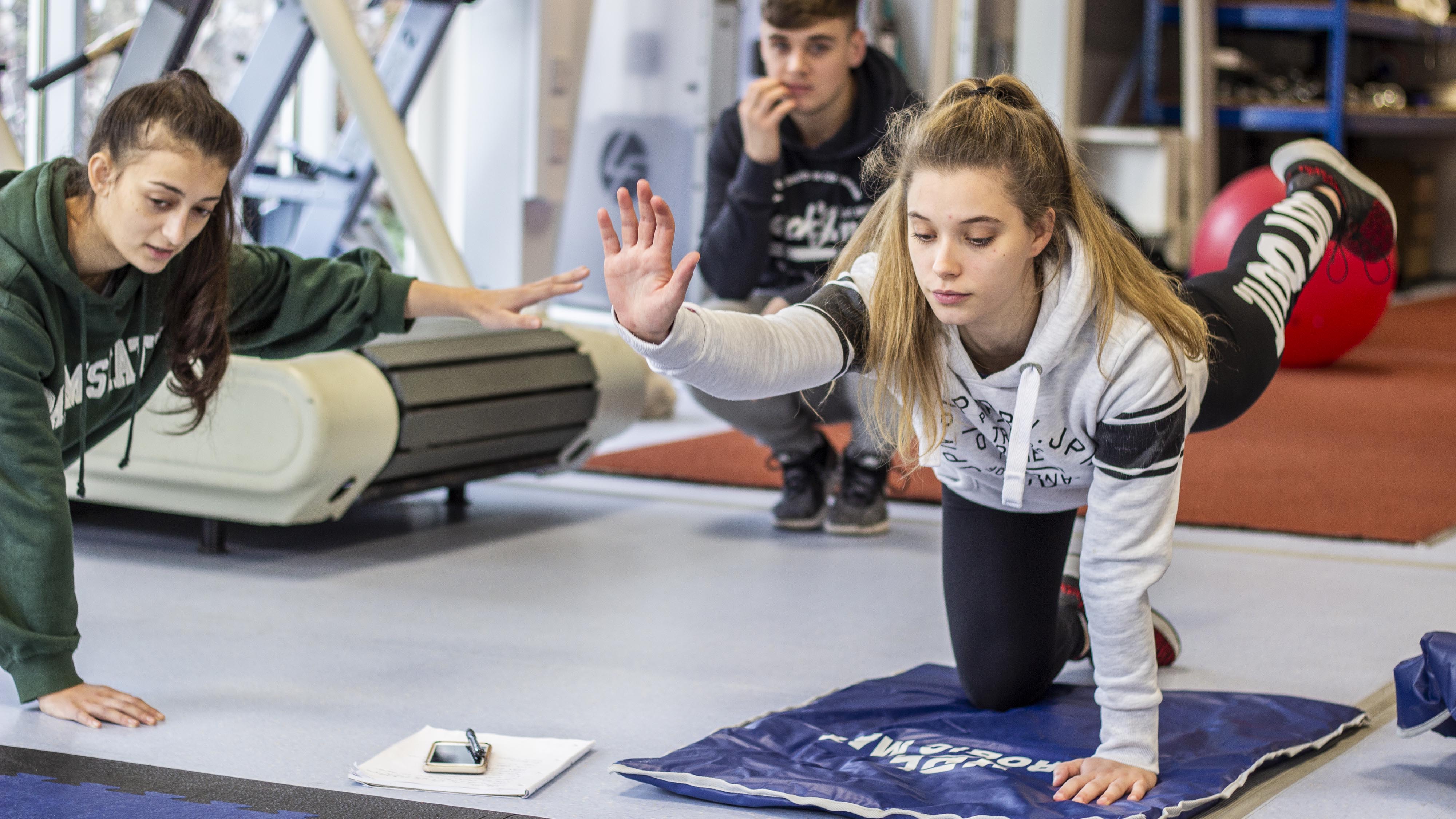 Conditioning student practices stretching exercise