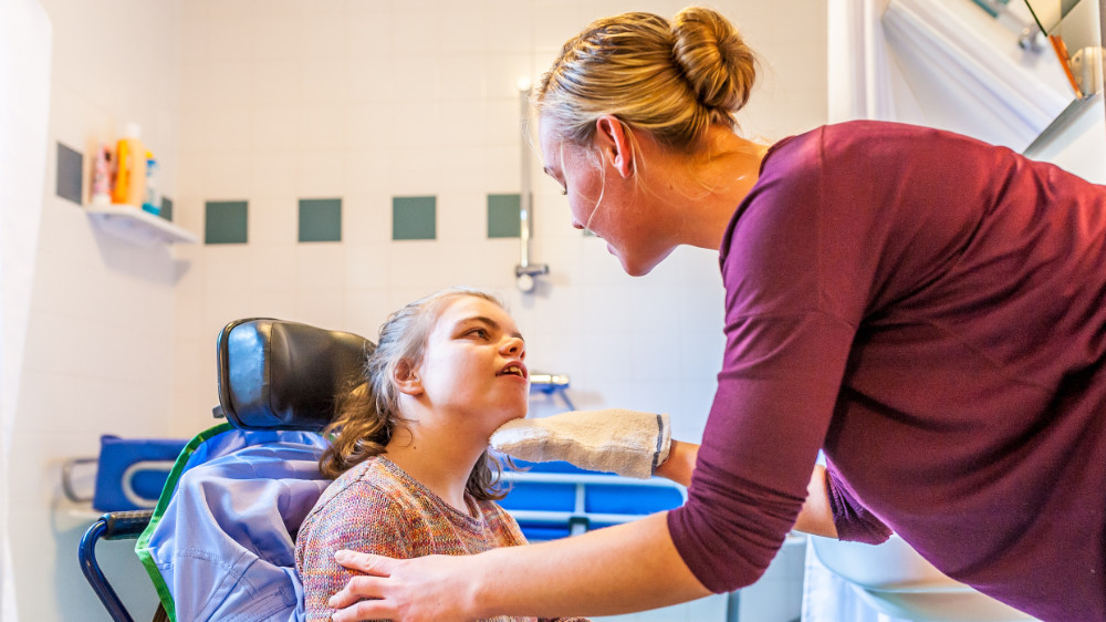 A nurse assisting someone with learning difficulties