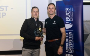 Man receives glass award from another man