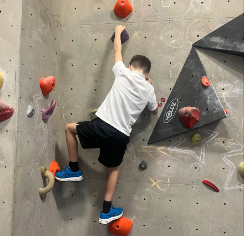 a child on a climbing wall