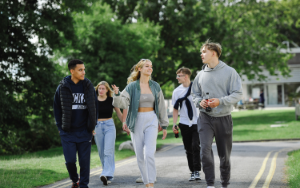 Group of students chatting and walking on campus