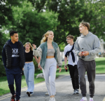 Group of students chatting and walking on campus