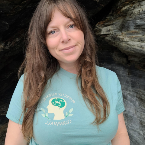 Smiling woman with brown hair and turquoise t-shirt