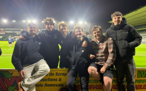 Student and smiling friends at football stadium