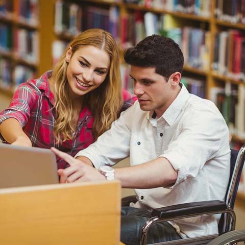 2 students looking at a laptop