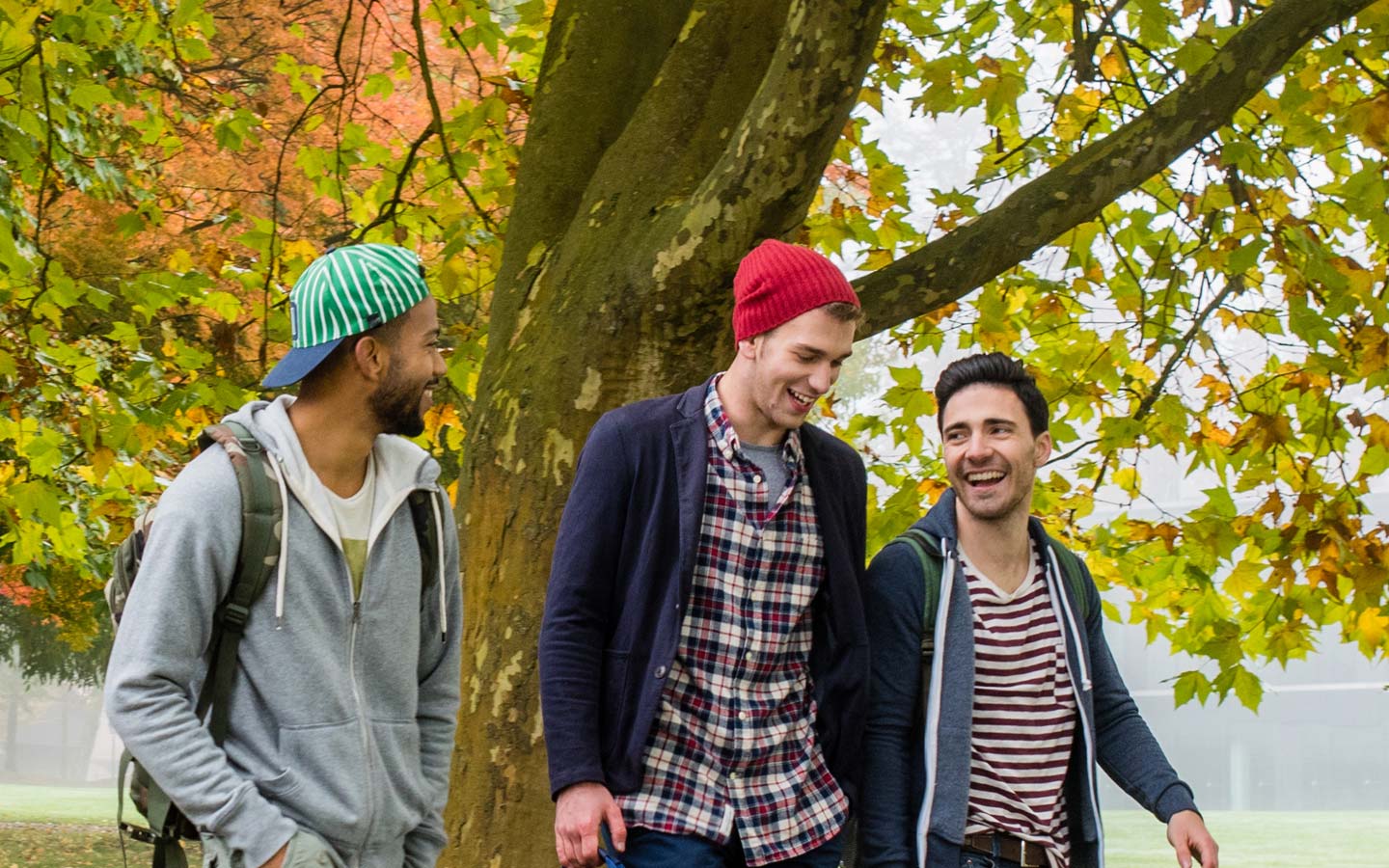 Three students walk together on campus