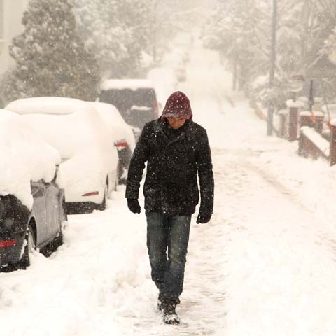 Man walking through snow