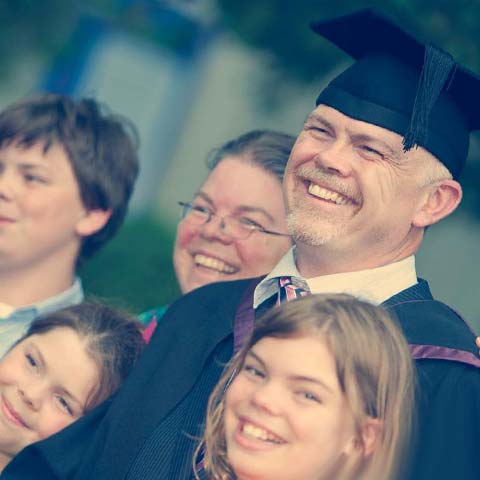 Mature male graduate and family